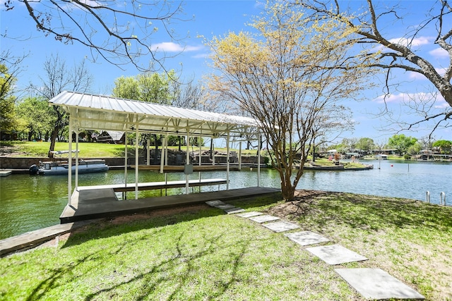 dock area with a water view and a lawn