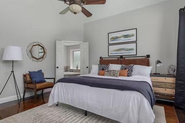 bedroom with ceiling fan, connected bathroom, and dark hardwood / wood-style flooring