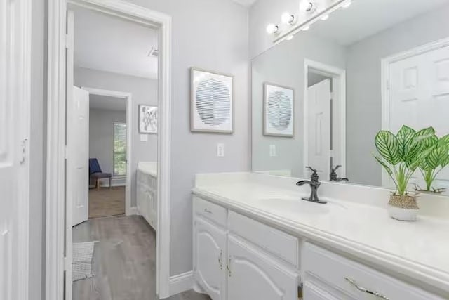 bathroom featuring hardwood / wood-style flooring and vanity