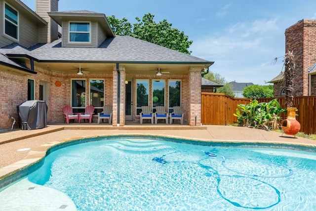 view of swimming pool with area for grilling, a patio, and ceiling fan