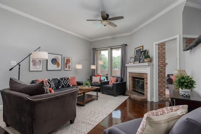 living room featuring tile patterned flooring, crown molding, ceiling fan, and a fireplace