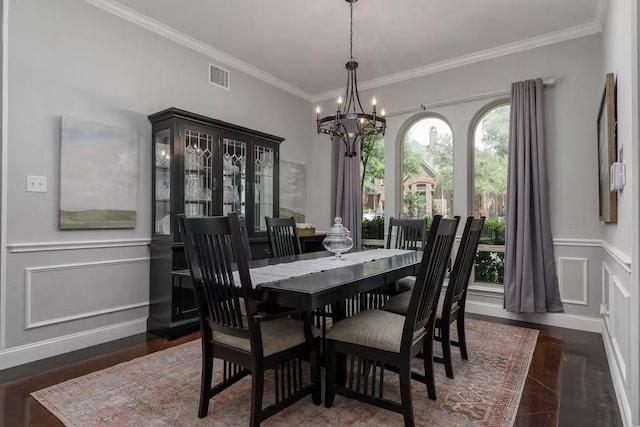 dining room with ornamental molding, dark wood-type flooring, and an inviting chandelier