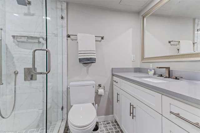 bathroom with vanity, an enclosed shower, and toilet