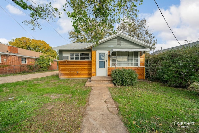 bungalow-style house featuring a front yard