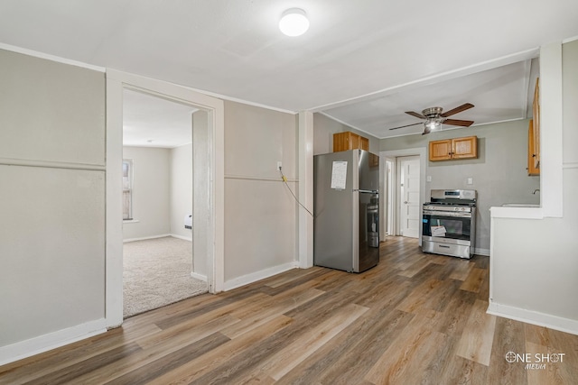 kitchen with sink, hardwood / wood-style flooring, ceiling fan, and appliances with stainless steel finishes