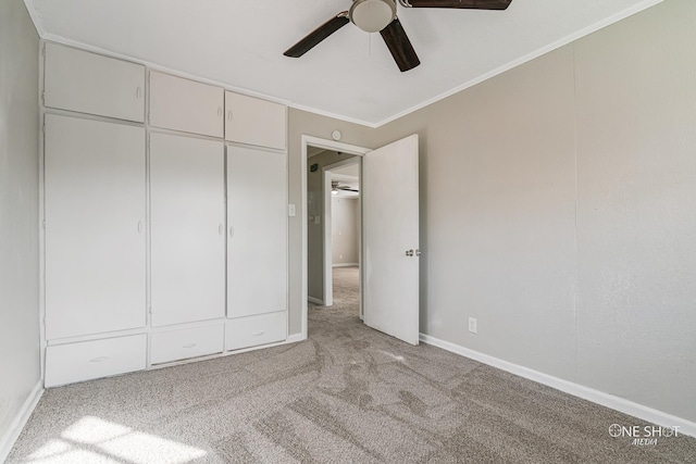 unfurnished bedroom with crown molding, light colored carpet, and ceiling fan