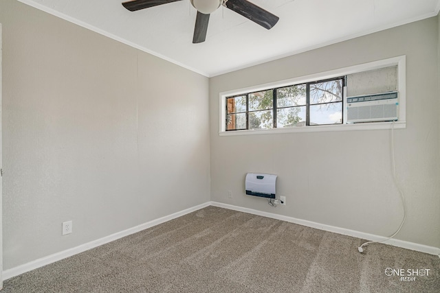 spare room featuring ceiling fan, ornamental molding, carpet floors, and heating unit