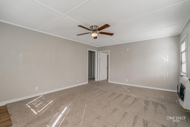 empty room with crown molding, heating unit, and ceiling fan