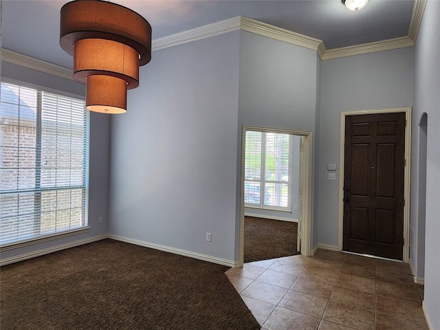 entrance foyer featuring crown molding and carpet flooring