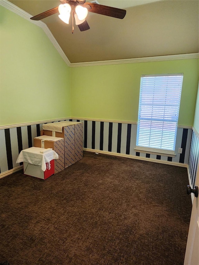 carpeted bedroom with lofted ceiling, crown molding, and ceiling fan