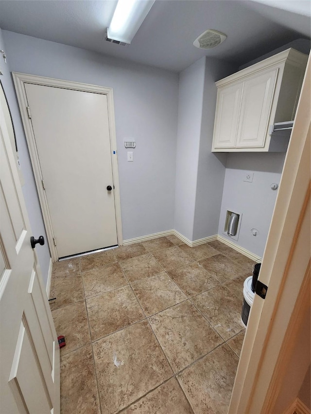 laundry area featuring cabinets, gas dryer hookup, and hookup for an electric dryer