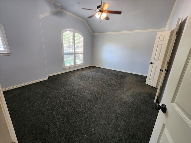 spare room with crown molding, ceiling fan, lofted ceiling, and dark carpet