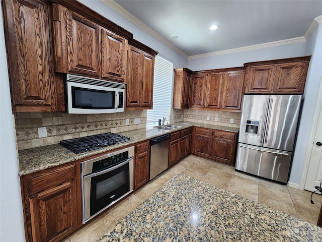 kitchen with sink, backsplash, stainless steel appliances, crown molding, and light stone countertops