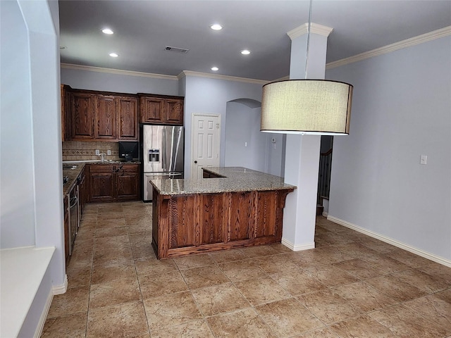 kitchen featuring crown molding, backsplash, a center island, light stone countertops, and stainless steel fridge with ice dispenser