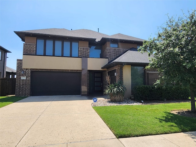 view of front of house with a balcony, a garage, and a front yard