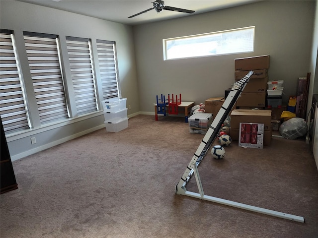 workout area with ceiling fan and carpet floors