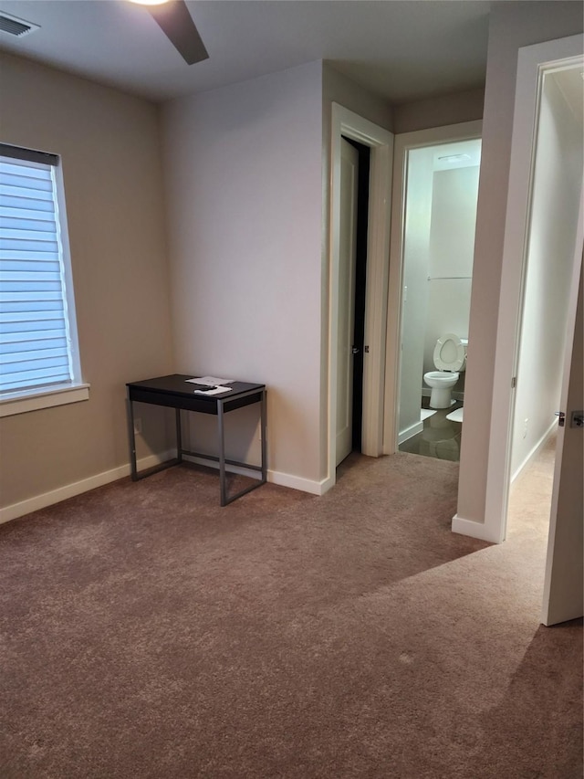 carpeted empty room featuring ceiling fan