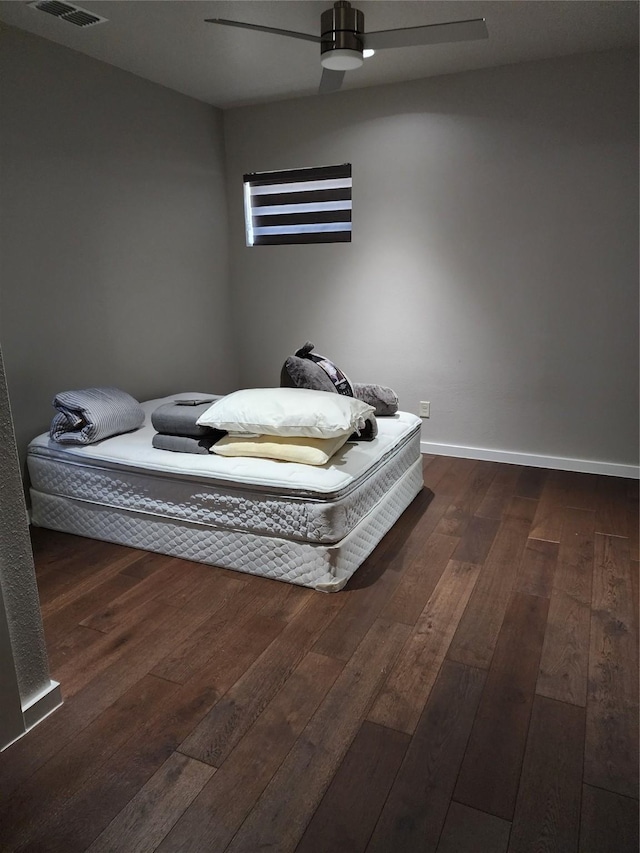 unfurnished bedroom with ceiling fan and dark hardwood / wood-style floors