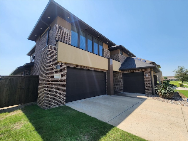 view of front of property with a garage, a balcony, and a front yard