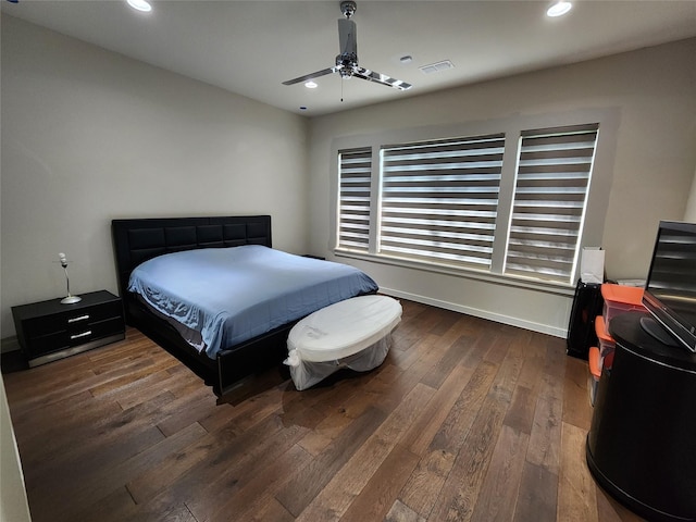 bedroom with ceiling fan and dark hardwood / wood-style floors