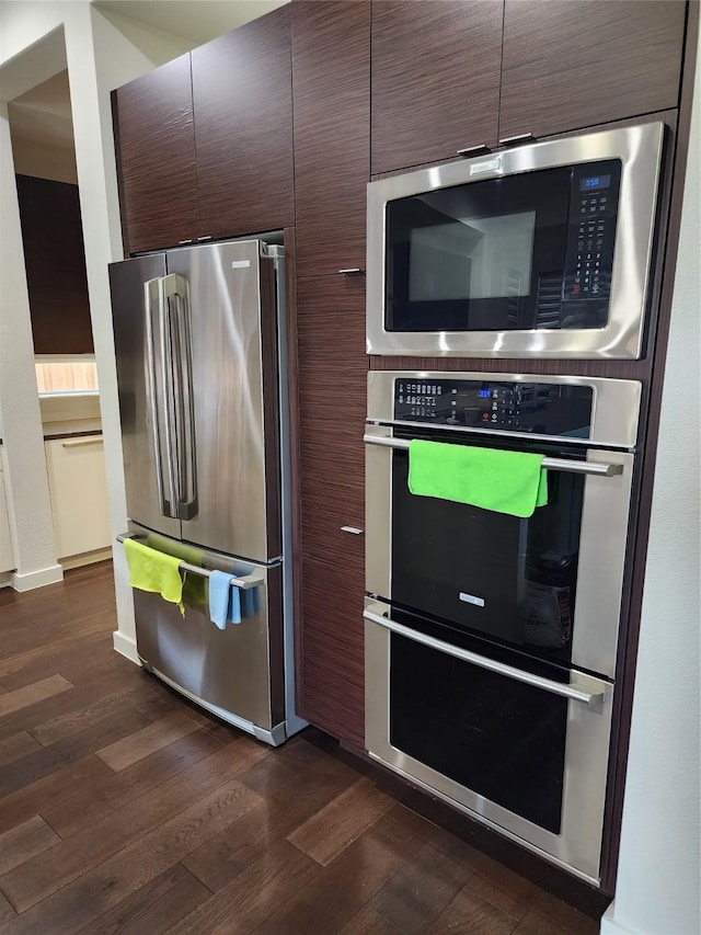 kitchen featuring dark brown cabinetry, dark hardwood / wood-style floors, and appliances with stainless steel finishes