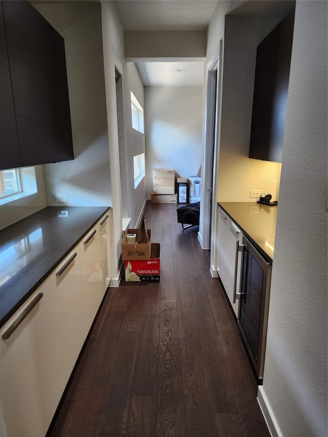 hall with dark hardwood / wood-style floors and wine cooler