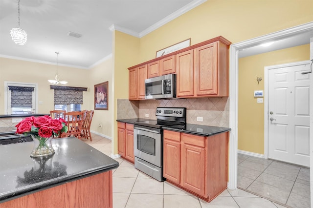 kitchen with light tile patterned floors, ornamental molding, appliances with stainless steel finishes, pendant lighting, and decorative backsplash