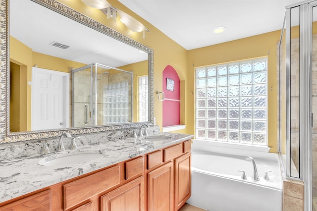 bathroom featuring vanity and separate shower and tub