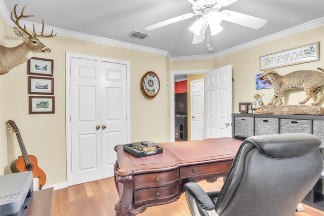 home office with crown molding, ceiling fan, and light hardwood / wood-style floors