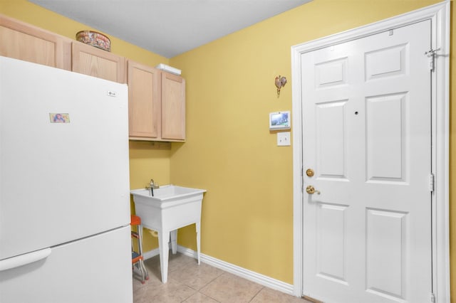 clothes washing area featuring light tile patterned floors