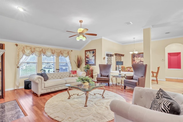 living room with crown molding, light hardwood / wood-style flooring, vaulted ceiling, and ceiling fan with notable chandelier