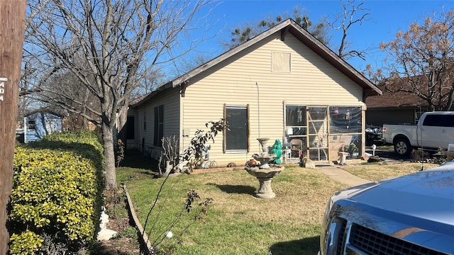 back of house with a lawn