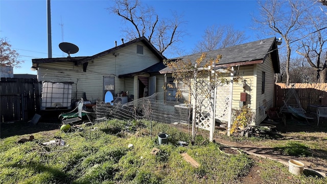 rear view of house with cooling unit