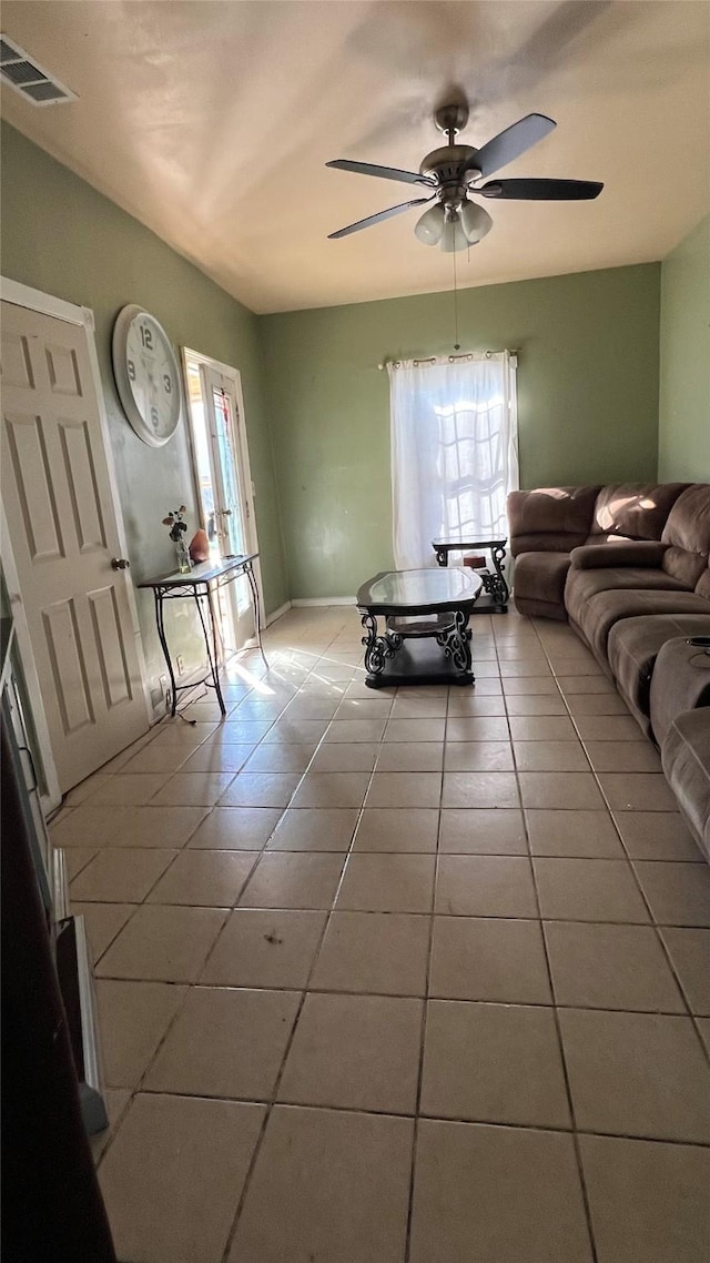 living room featuring light tile patterned floors and ceiling fan