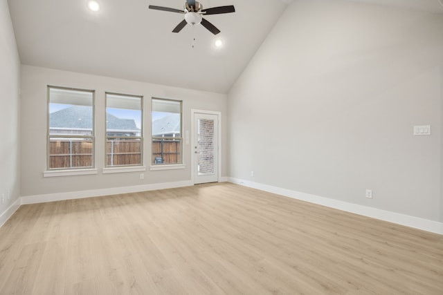 spare room featuring ceiling fan, high vaulted ceiling, and light wood-type flooring