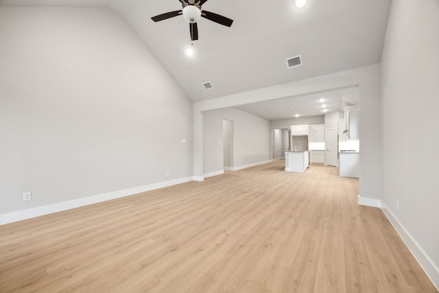 unfurnished living room featuring ceiling fan, lofted ceiling, and light wood-type flooring