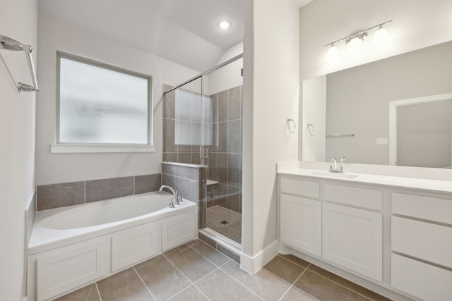 bathroom with tile patterned floors, separate shower and tub, and vanity