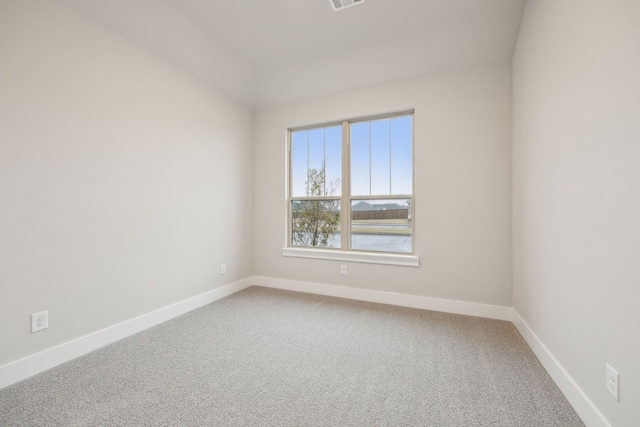 carpeted empty room featuring a water view