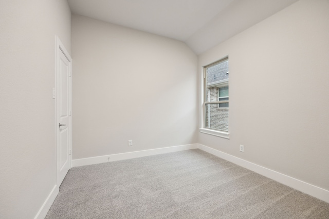 spare room with lofted ceiling and carpet