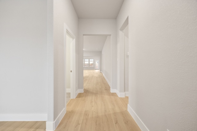 corridor with light wood-type flooring