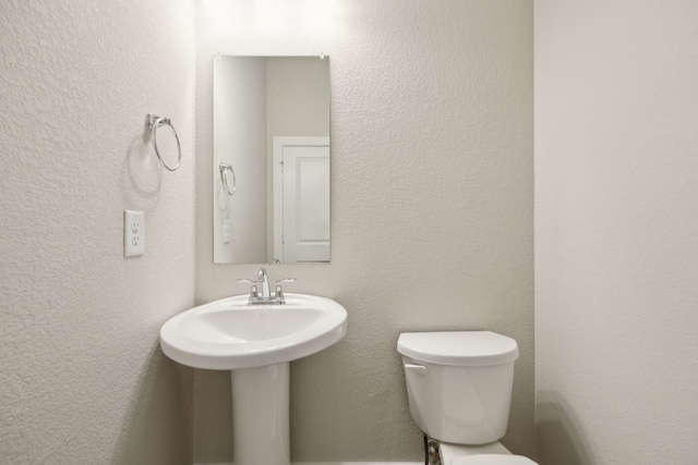 bathroom featuring sink and toilet