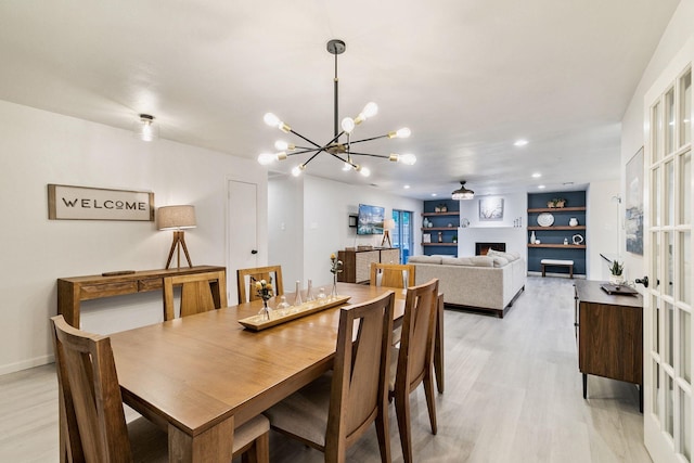 dining area featuring a notable chandelier and light hardwood / wood-style floors