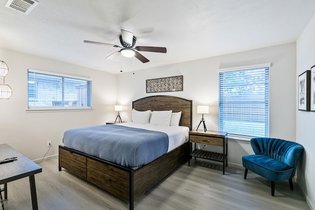 bedroom with light hardwood / wood-style flooring and ceiling fan