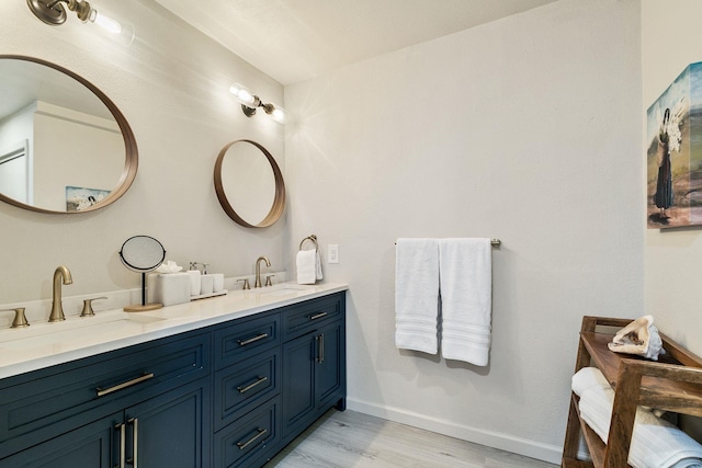 bathroom with hardwood / wood-style flooring and vanity