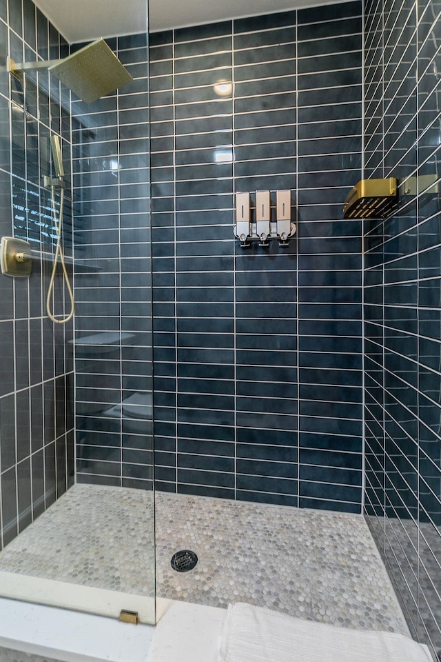 bathroom with tiled shower