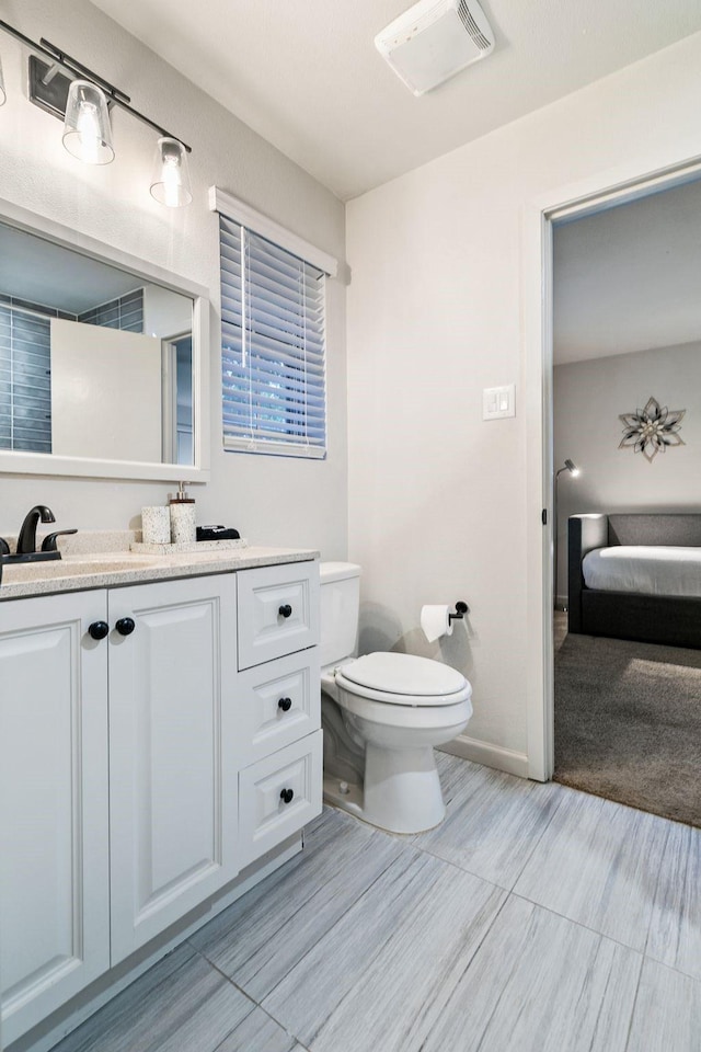 bathroom with vanity and toilet