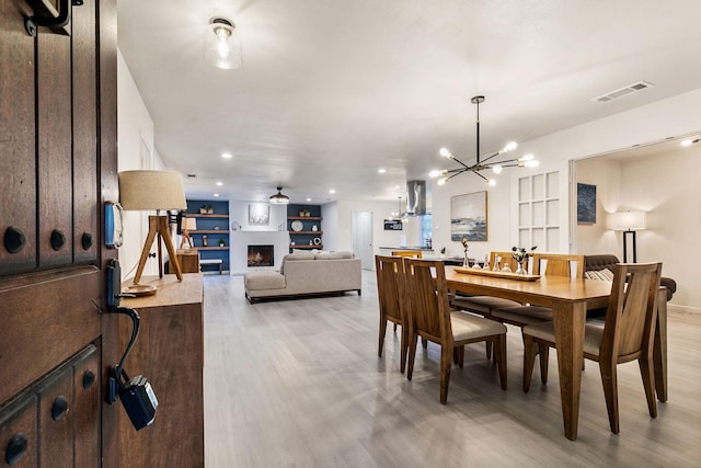 dining space with hardwood / wood-style flooring and built in features