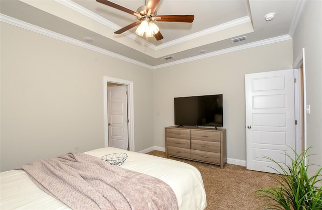 bedroom with ceiling fan, ornamental molding, a raised ceiling, and carpet