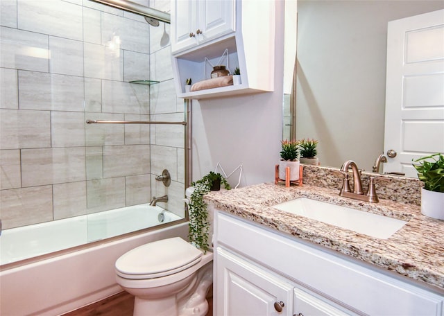 full bathroom with toilet, vanity, bath / shower combo with glass door, and hardwood / wood-style floors