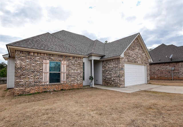 view of front of home with a garage and a front lawn